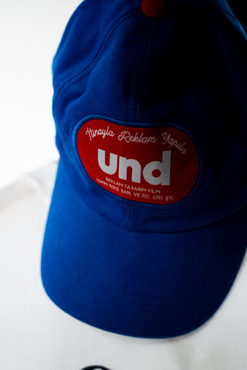 Und blue cap with "Und Badge"