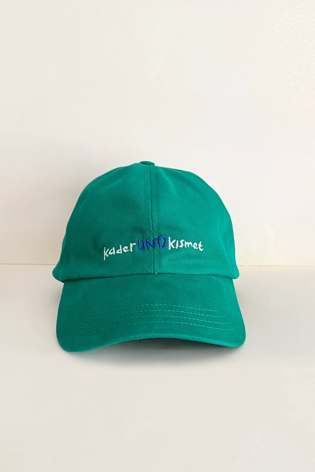 Und green cap with "Kader und Kısmet" embroidery